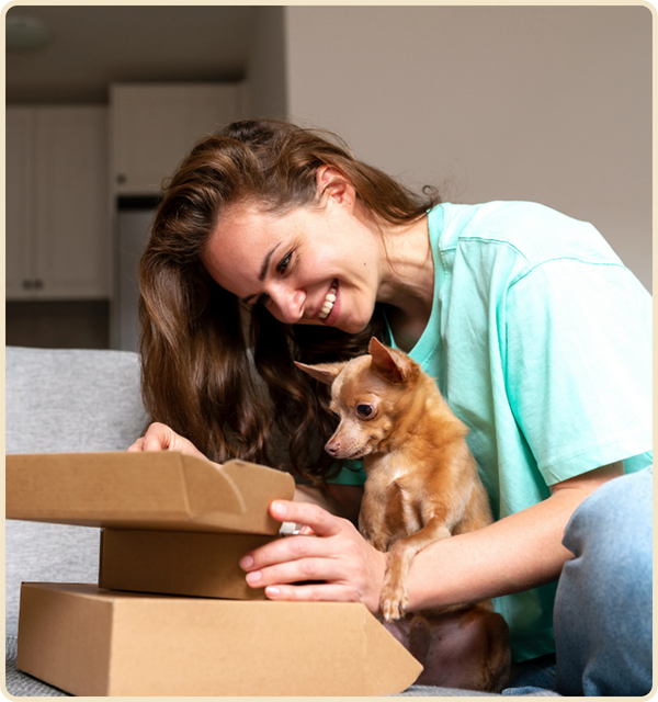 Happy dog and owner opening a subscription box